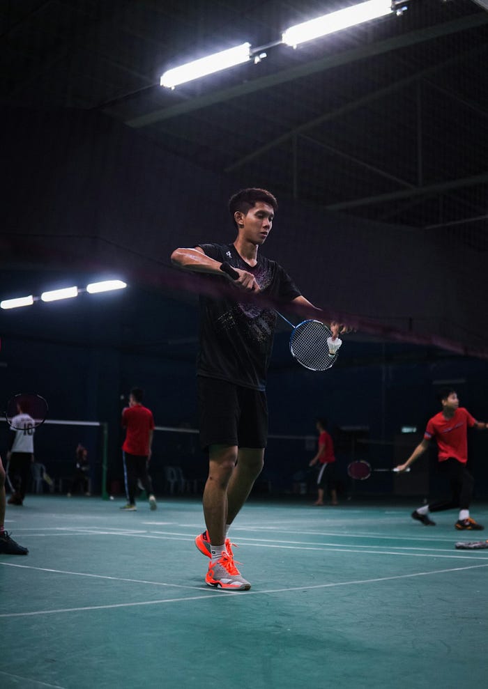 Badminton player in action illustrating focus and strategy.